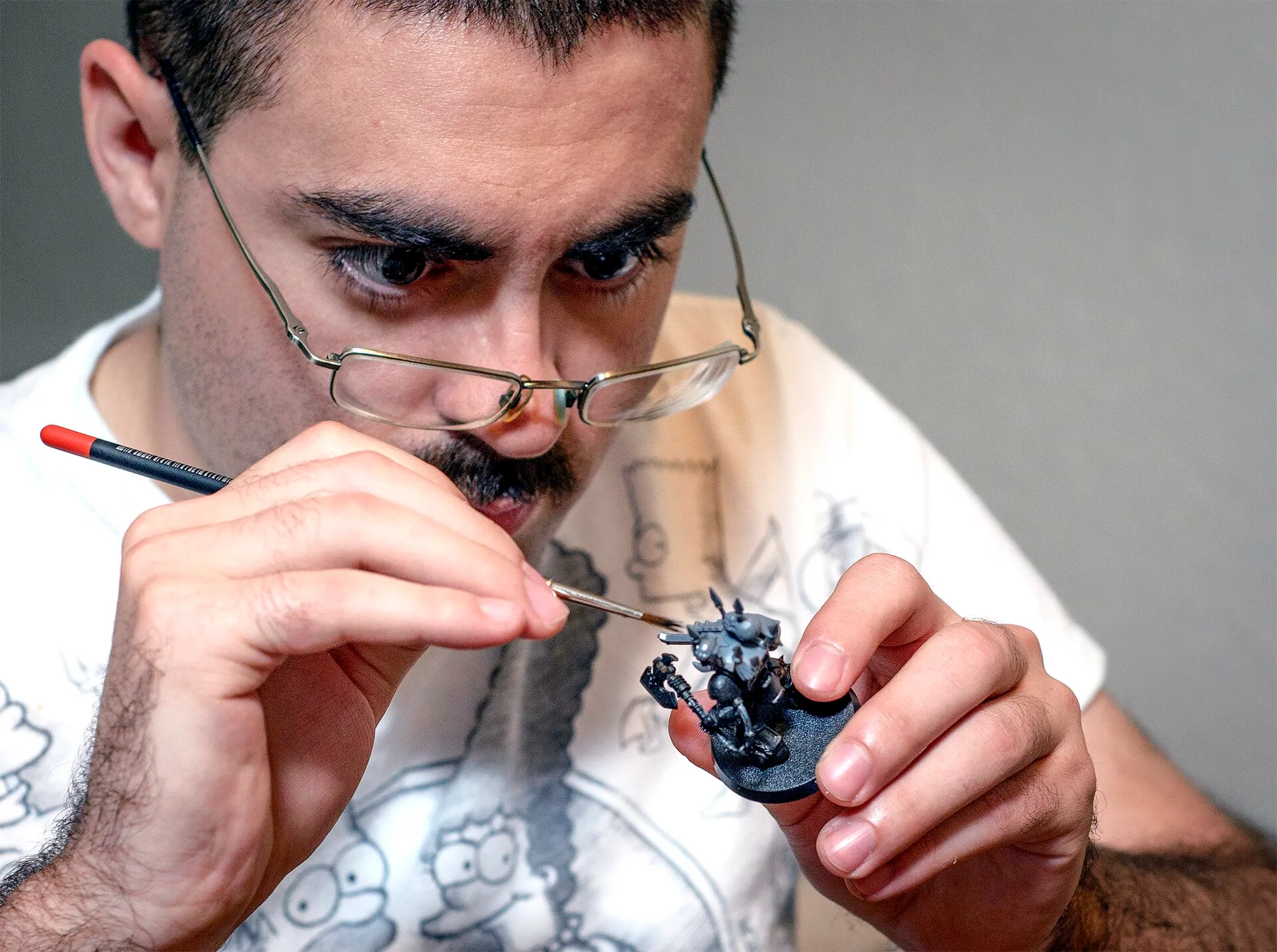 Senior Airman Thomas White, a 71st Operations Support Squadron Airman, enjoys some downtime as he customizes Warhammer 40,000 units at his home in Enid, Oklahoma, June 16. (U.S. Air Force photo / David Poe) The miniature model in question is a Chaos Space Marine in Terminator armor. Miniature project costs makers track as sole proprietors